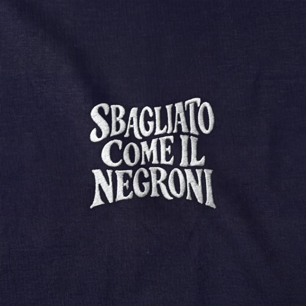 Dettaglio ricamo bianco Sbagliato come il Negroni su blu